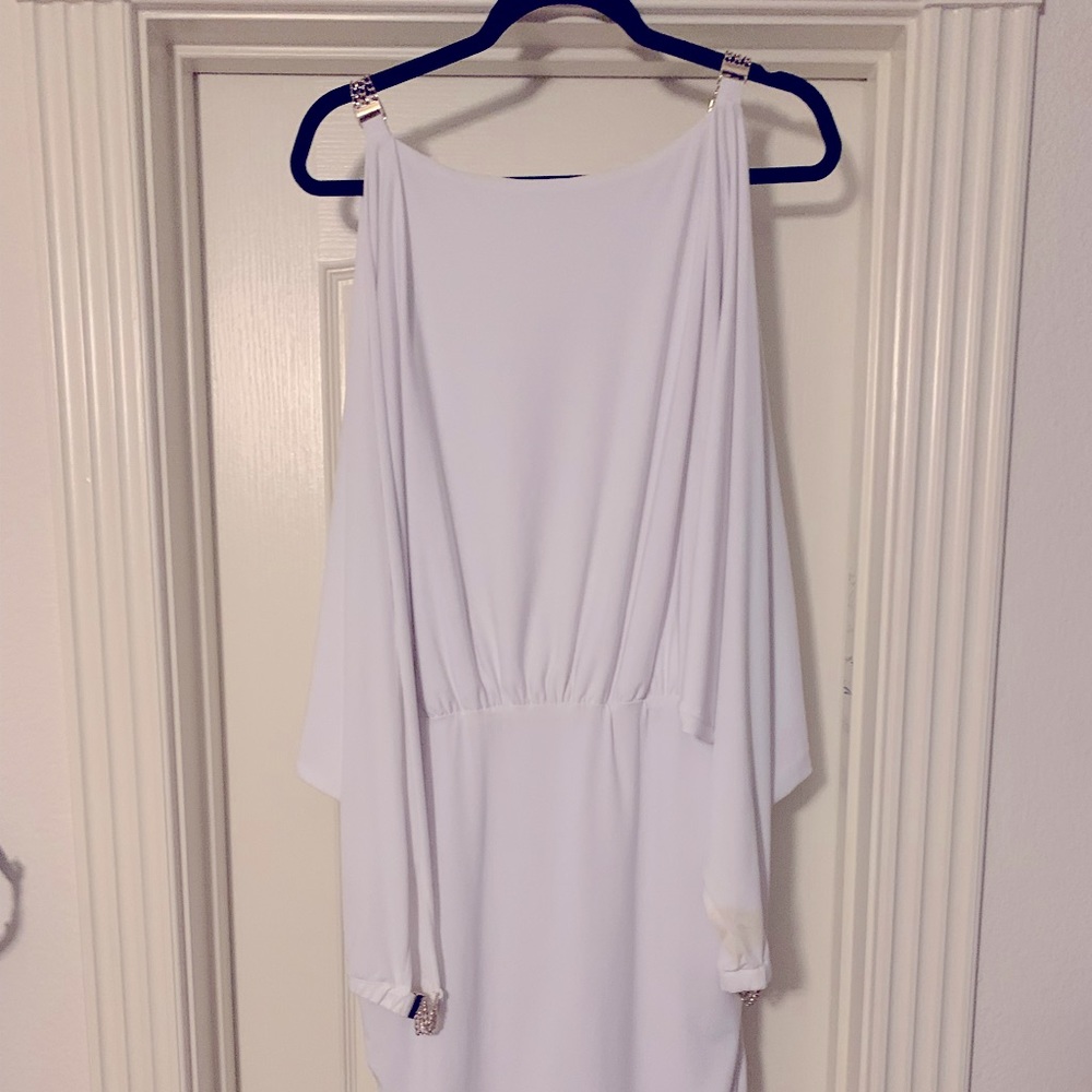 Women’s cold shoulder dress with gold chain detail.
